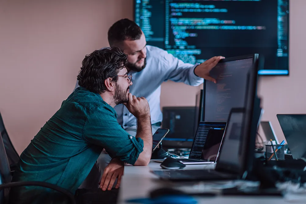 Developers collaborating together at a workstation