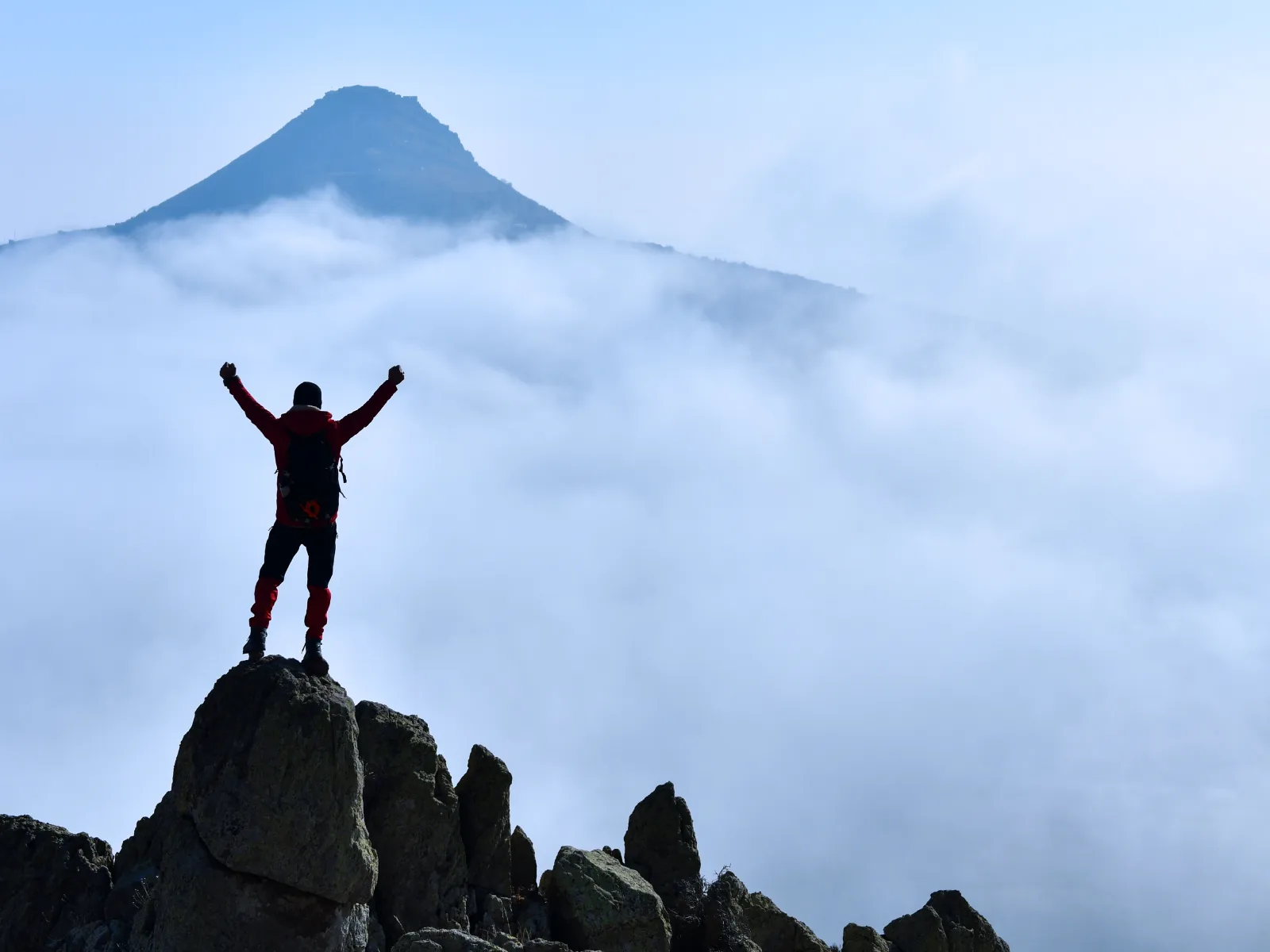 Professional standing on a mountain peak