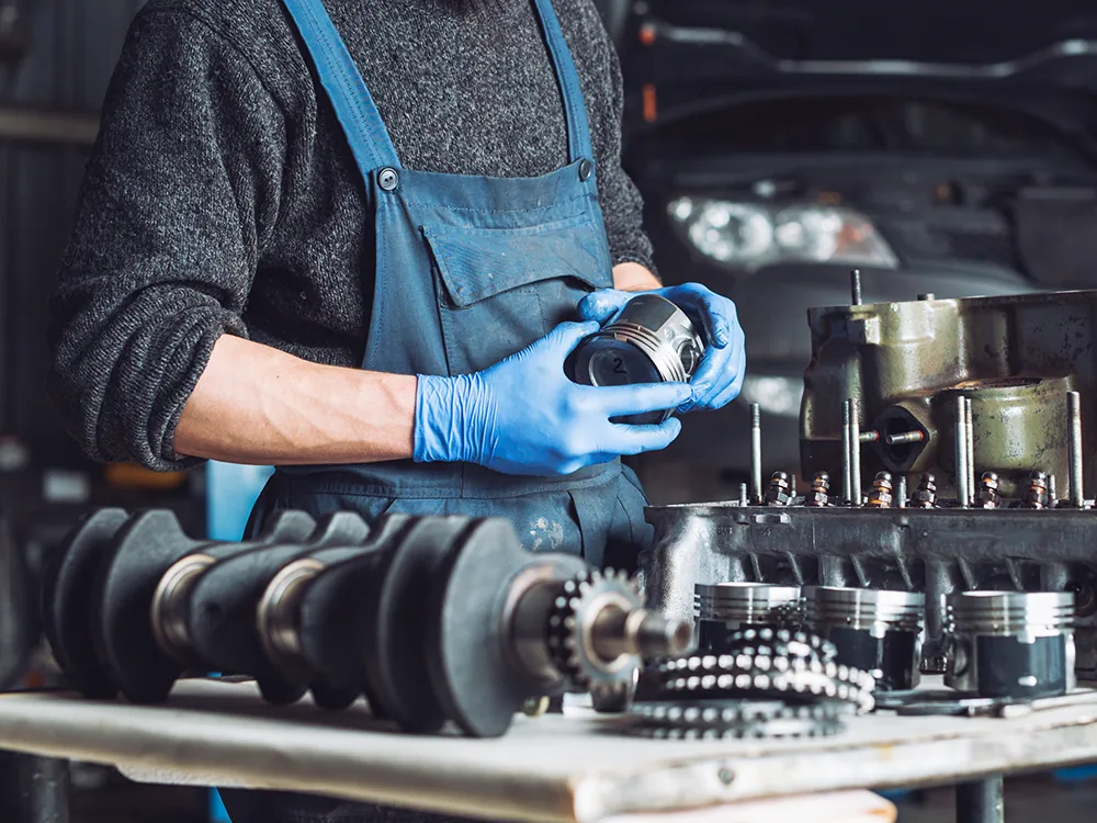 Mechanic inspecting car parts