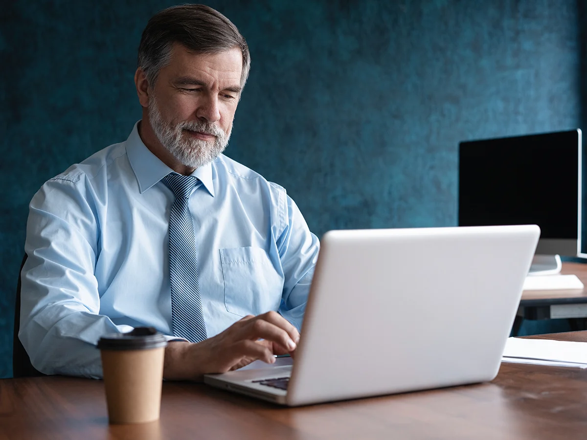 Professional reviewing account activity on a laptop